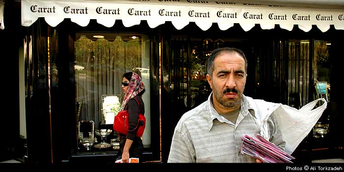 Akbar Moradi, 38, peddling pantyhose in front of the Carat store, on the exclusive Africa Ave., north Tehran.