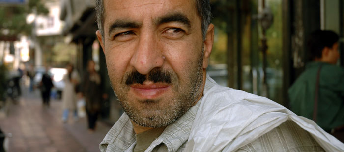 Akbar Moradi, 38, peddling pantyhose in front of the Carat store, on the exclusive Africa Ave., north Tehran.